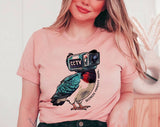 "Birds Aren't Real" design on a peach unisex t-shirt