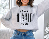 "Stay Humble, Hustle Hard" design on an ash gray unisex crewneck sweatshirt