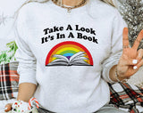 "Take A Look, It's In A Book" design on an ash gray unisex crewneck sweatshirt