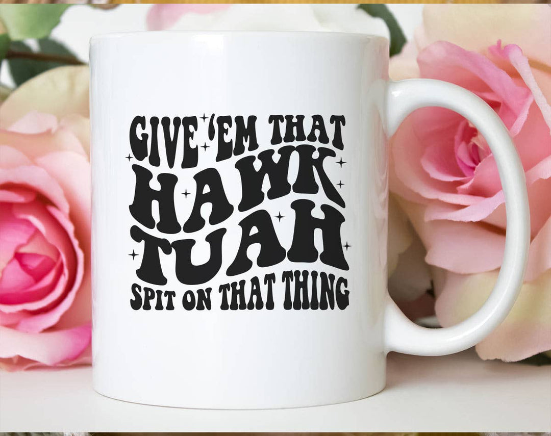 "Give'em That Half Hawk Tuah" design on a white ceramic coffee mug