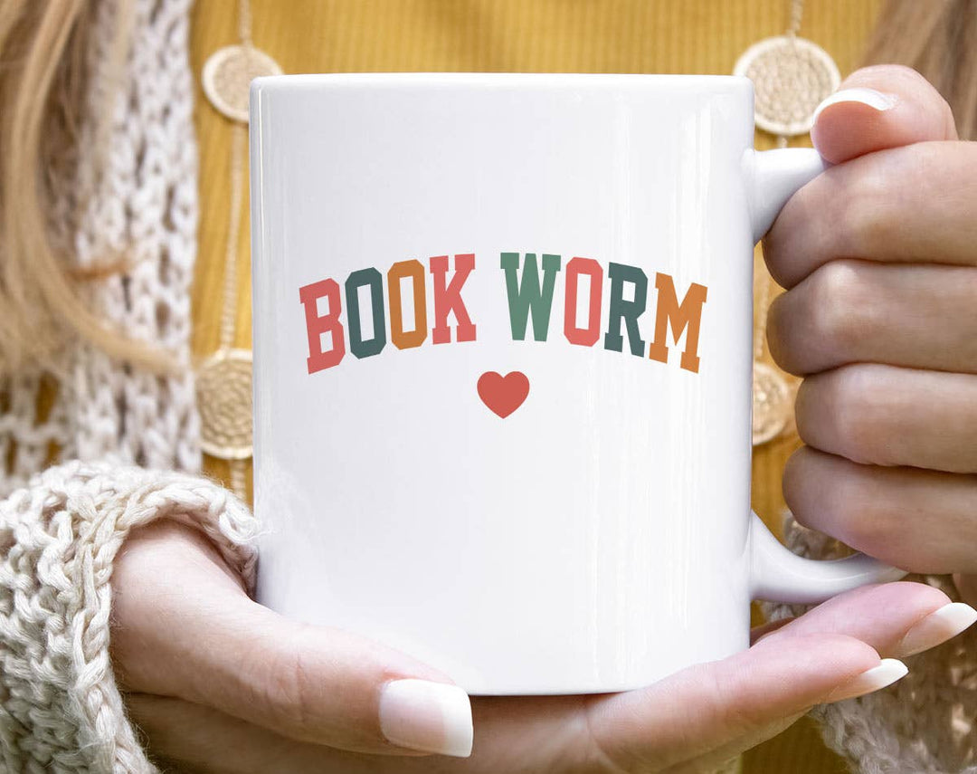 "Bookworm Heart" design on a white ceramic coffee mug