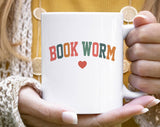 "Bookworm Heart" design on a white ceramic coffee mug