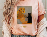"Oopsie Van Gogh Sunflowers Black Cat" design on a peach unisex t-shirt