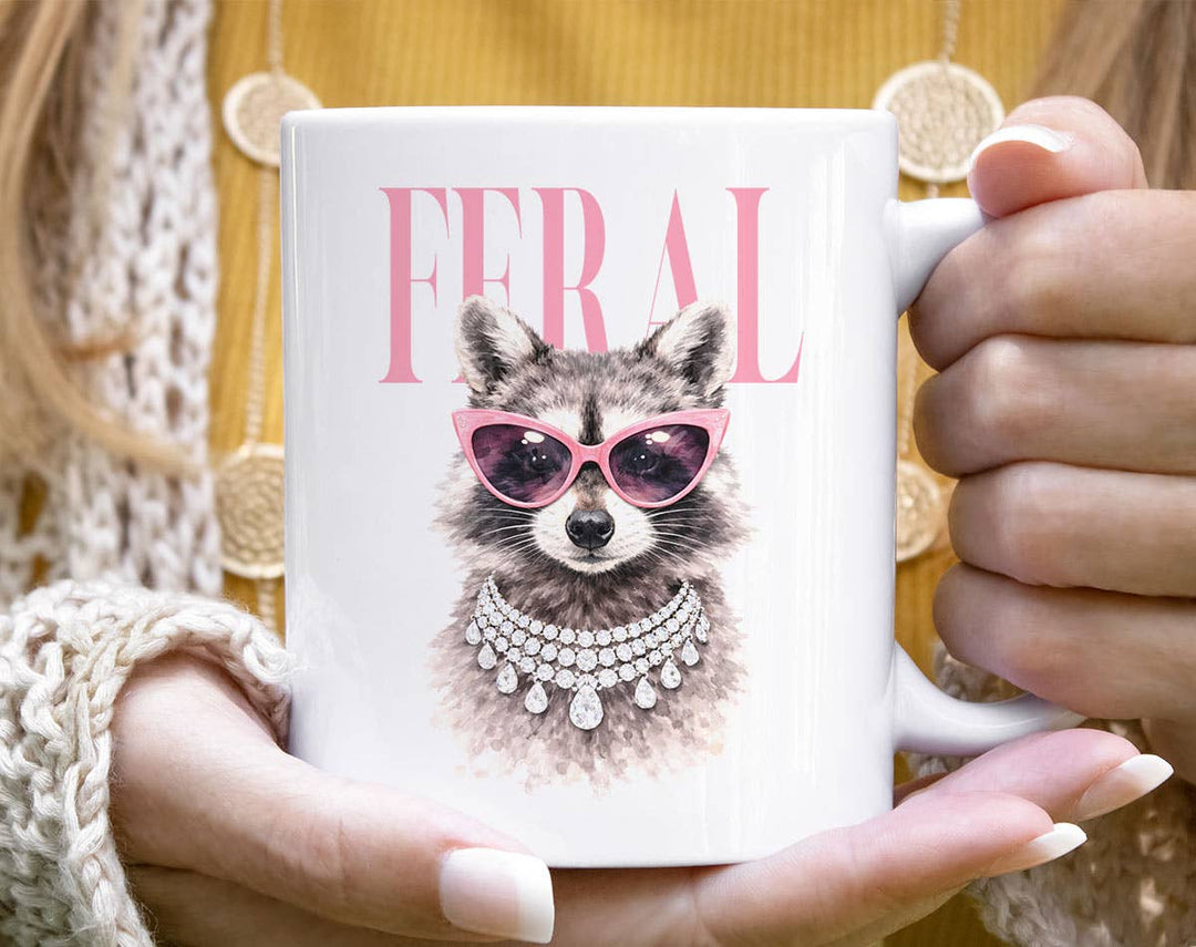 "Feral Vogue Raccoon" design on a white ceramic coffee mug