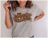 "Spooky Season Ghost" design on a heather gray unisex t-shirt