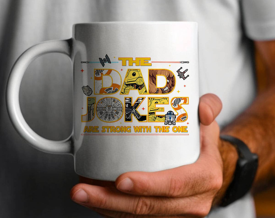 "The Dad Jokes Are Strong Funny Fathers Day" design on a white ceramic coffee mug