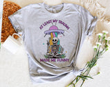 "At Least My Trauma Made Me" design on a heather gray unisex t-shirt