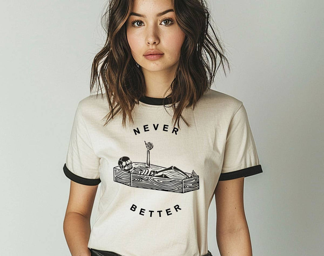 "Never Better Skeleton Coffin" design on a natural ringer t-shirt with black contrast trim