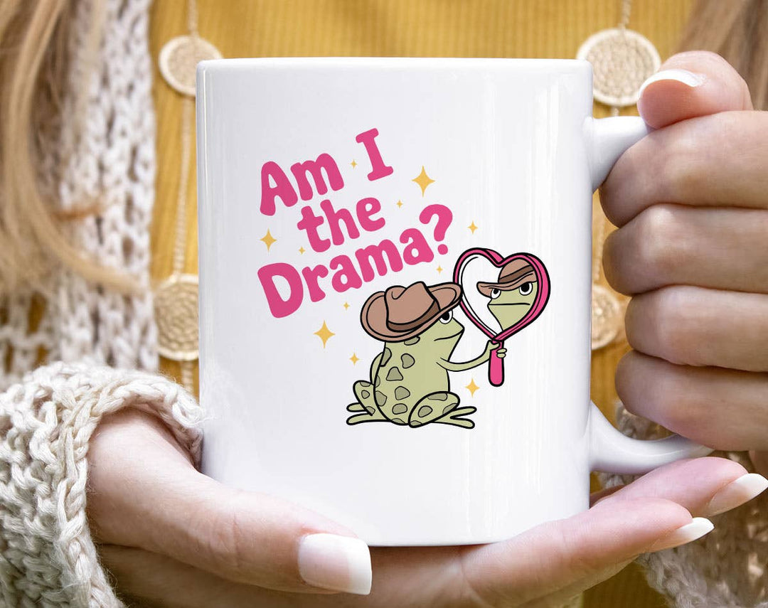 "Am I The Drama?" design on a white ceramic coffee mug