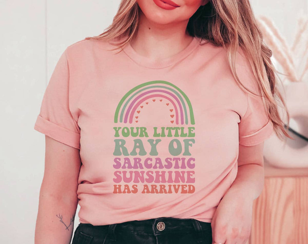 "Your Little Ray Of Sarcastic Sunshine" design on a peach unisex t-shirt