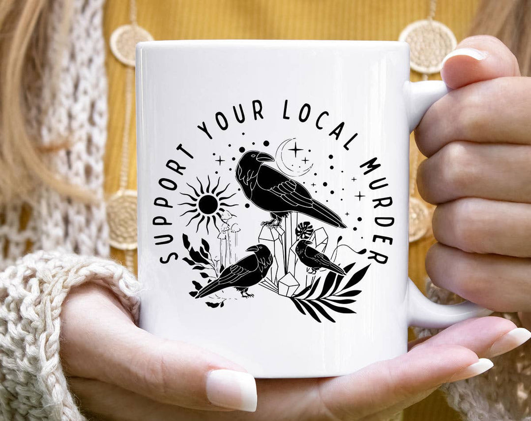 "Support Your Local Murder" design on a white ceramic coffee mug
