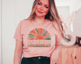 "Sunkissed Rainbow" design on a peach unisex t-shirt