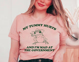 "My Tummy Hurts Frog" design on a peach unisex t-shirt