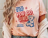 "You Go Girl" design on a peach unisex t-shirt