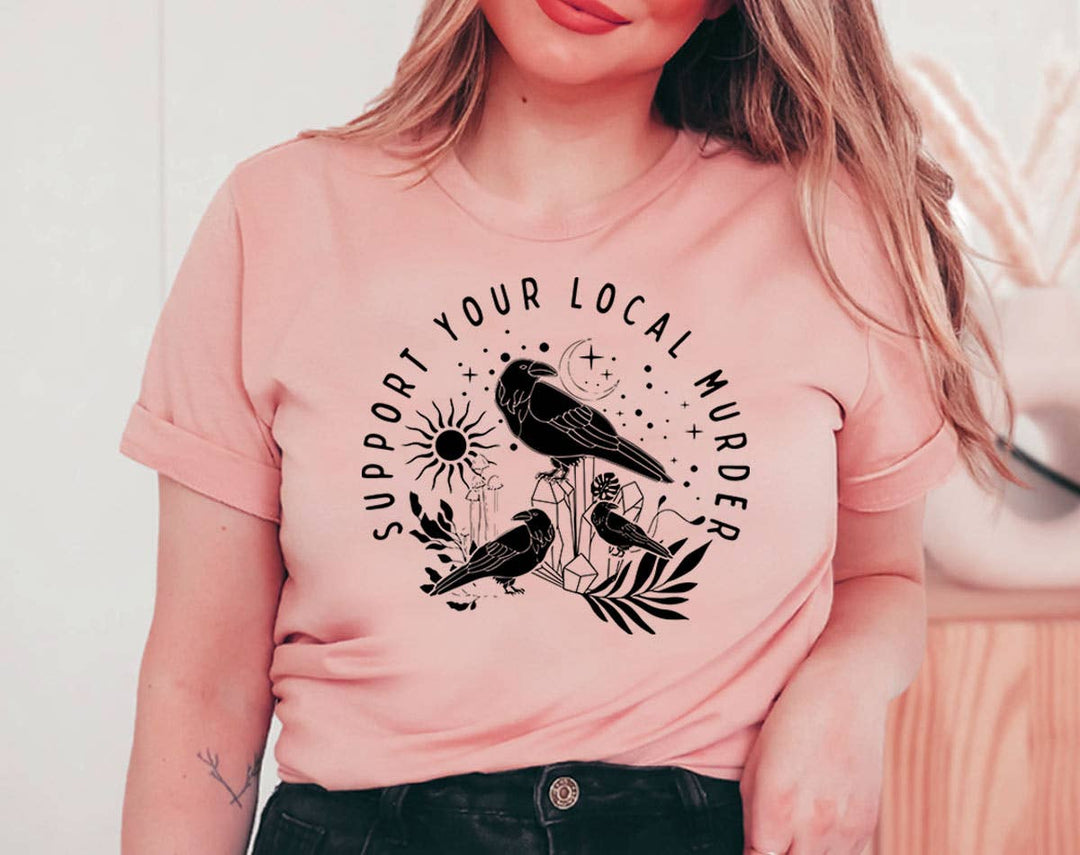 "Support Your Local Murder Crow" design on a peach unisex t-shirt