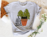 "I Just Need Cats And Plants" design on a heather gray unisex t-shirt