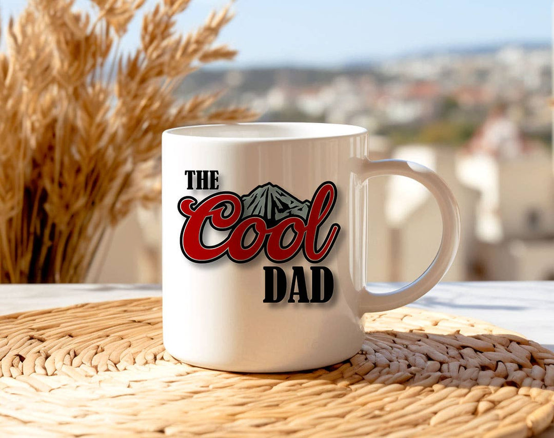 "The Cool Dad" design on a white ceramic coffee mug