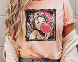 "Cupid Bubblegum Stamp" design on a peach unisex t-shirt