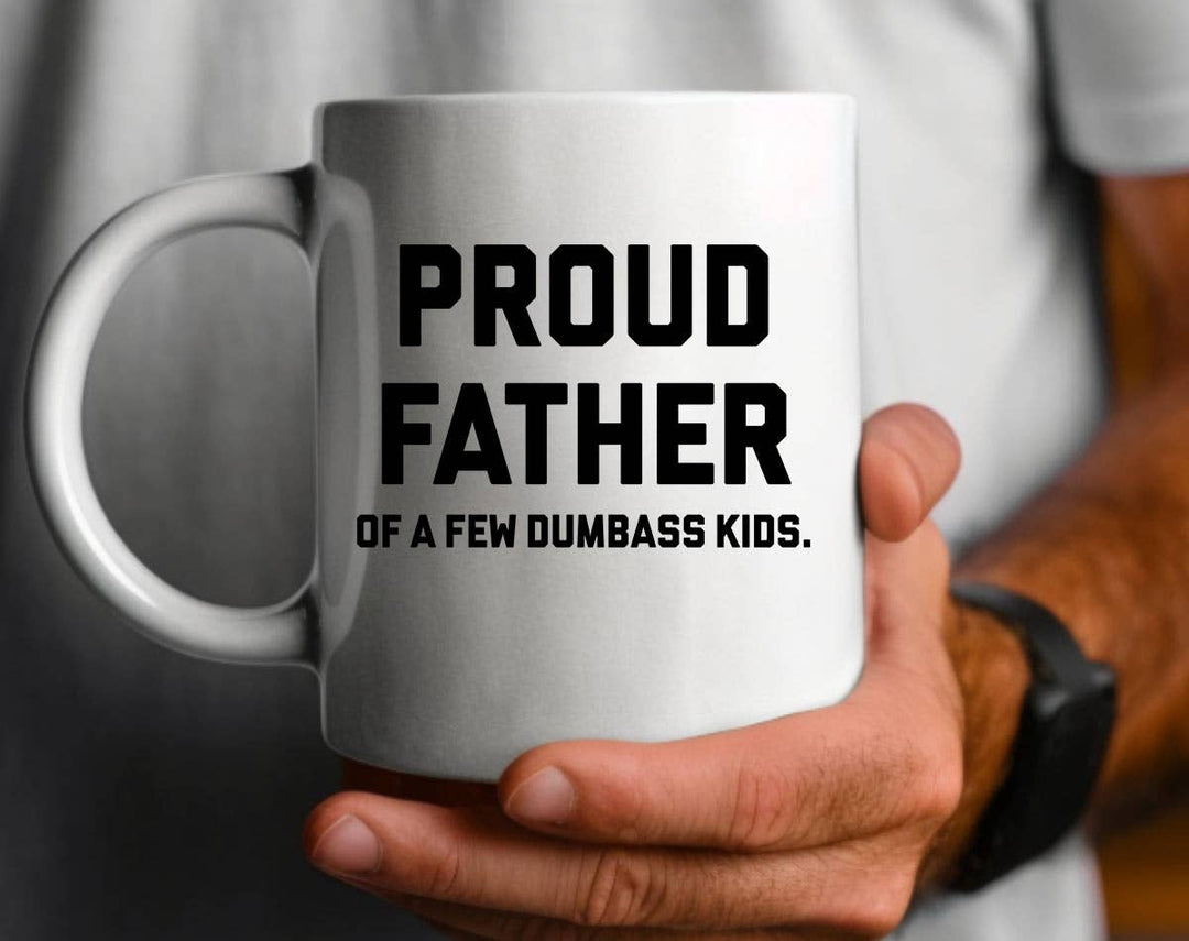 "Proud Father Of Dumbass Kids" design on a white ceramic coffee mug