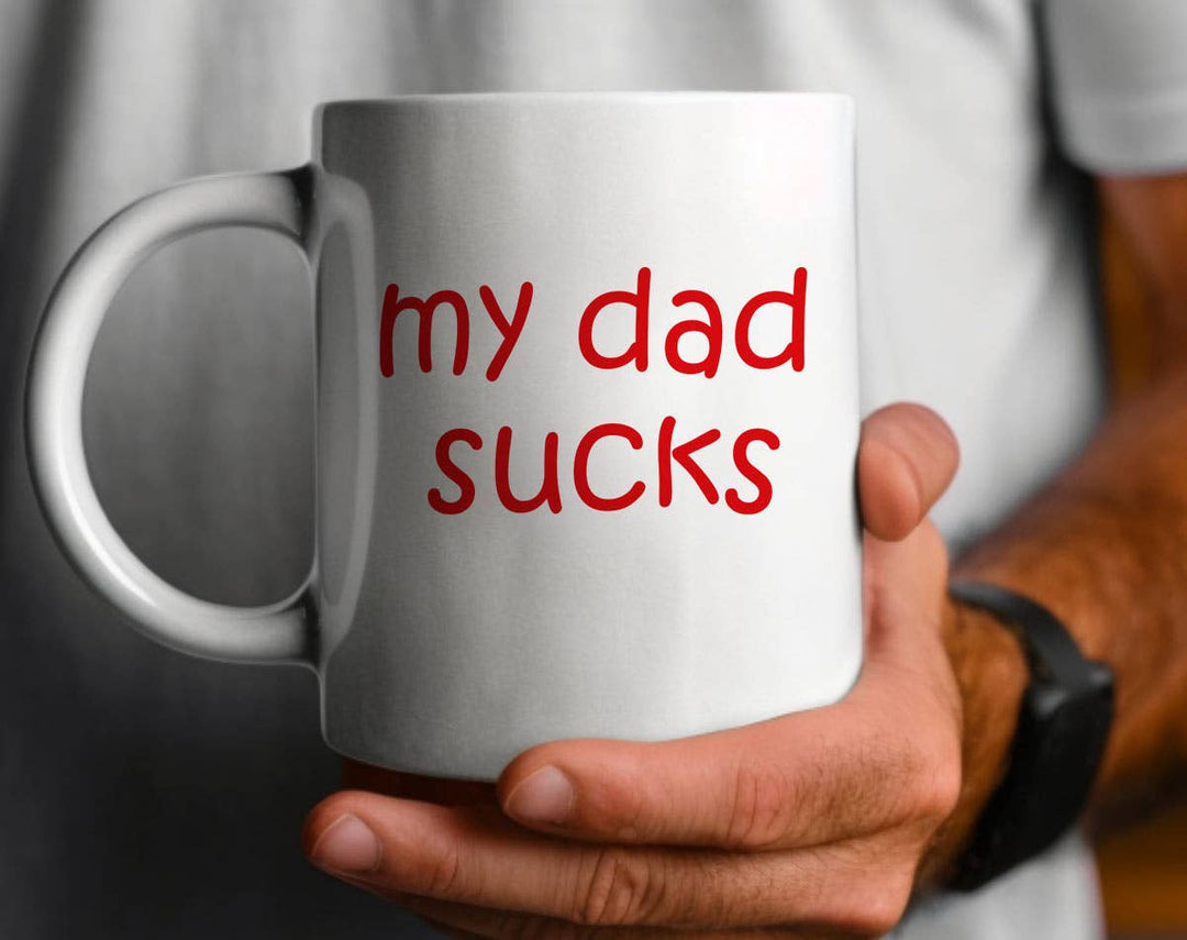 "My Dad Sucks" design on a white ceramic coffee mug