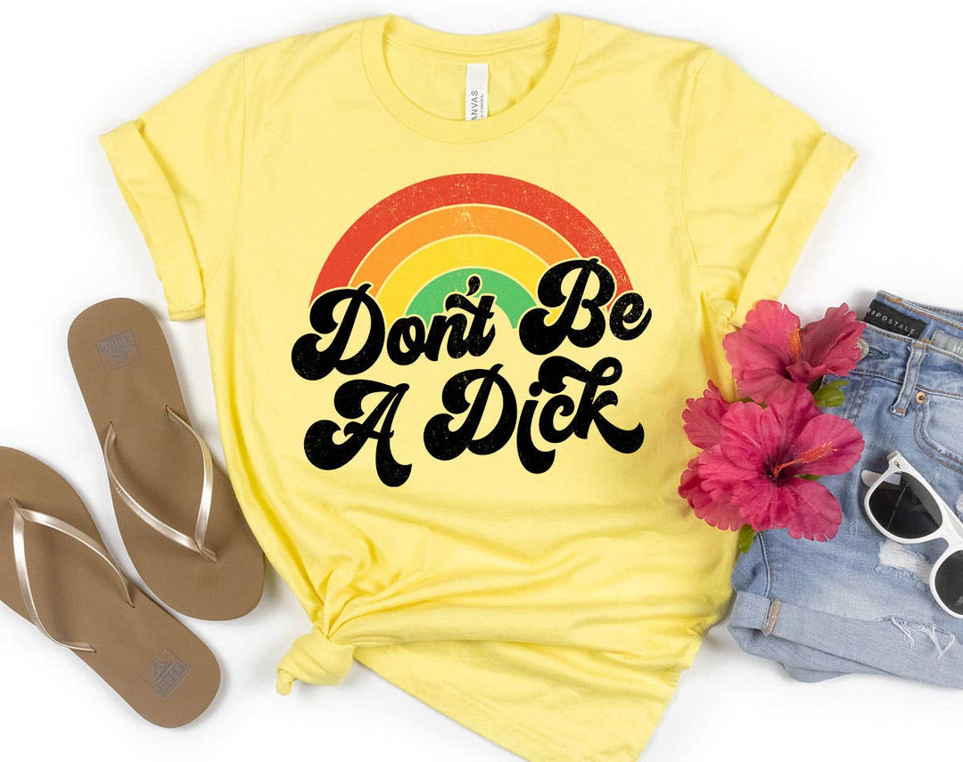 "Don't Be A D*ck Rainbow" design on a pale yellow unisex t-shirt