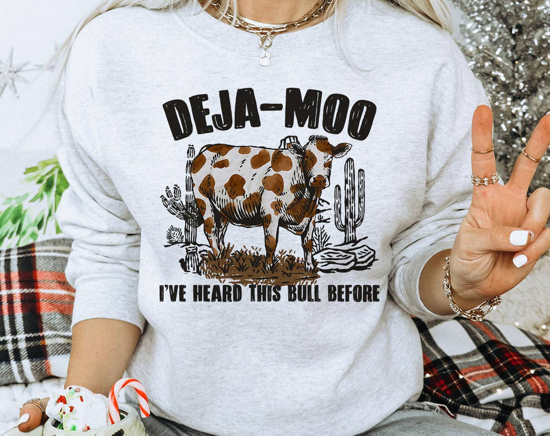 "Deja Moo, Heard This Bull Before" design on an ash gray unisex crewneck sweatshirt