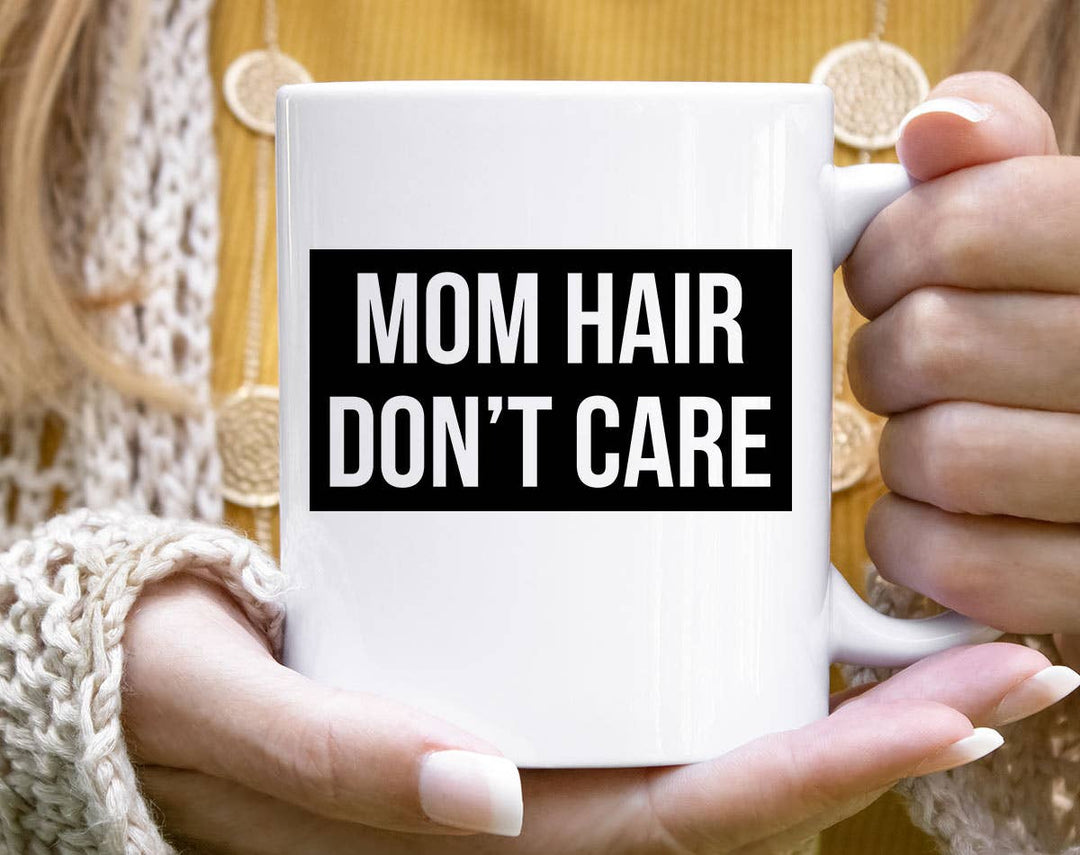 "Mom Hair Don't Care" design on a white ceramic coffee mug
