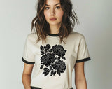 "Retro Linocut Black Peonies Floral" design on a natural ringer t-shirt with black contrast trim
