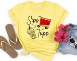 "Sips & Trips" design on a pale yellow unisex t-shirt