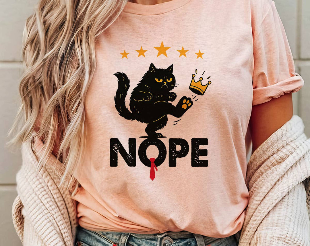 "Nope No Kings Black Cat" design on a peach unisex t-shirt