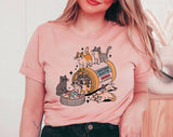 "Serotonin Booster Cats" design on a peach unisex t-shirt