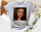 "Disgusted Doll Face Meme" design on a heather gray unisex t-shirt