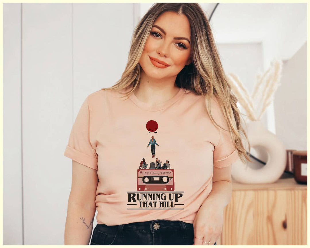 "Running Up That Hill" design on a peach unisex t-shirt