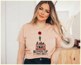 "Running Up That Hill" design on a peach unisex t-shirt