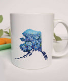 "Alaska State Flower Forget Me Not" design on a white ceramic coffee mug