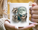 "3 Raccoons Howling" design on a white ceramic coffee mug