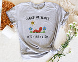 "Wake Up Sluts, It's Time To Sin" design on a unisex t-shirt