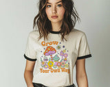 "Grow Your Own Way Mushroom" design on a natural ringer t-shirt with black contrast trim