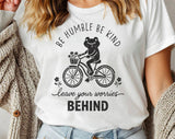 "Be Humble Be Kind Frog Bicycle" design on a white unisex t-shirt