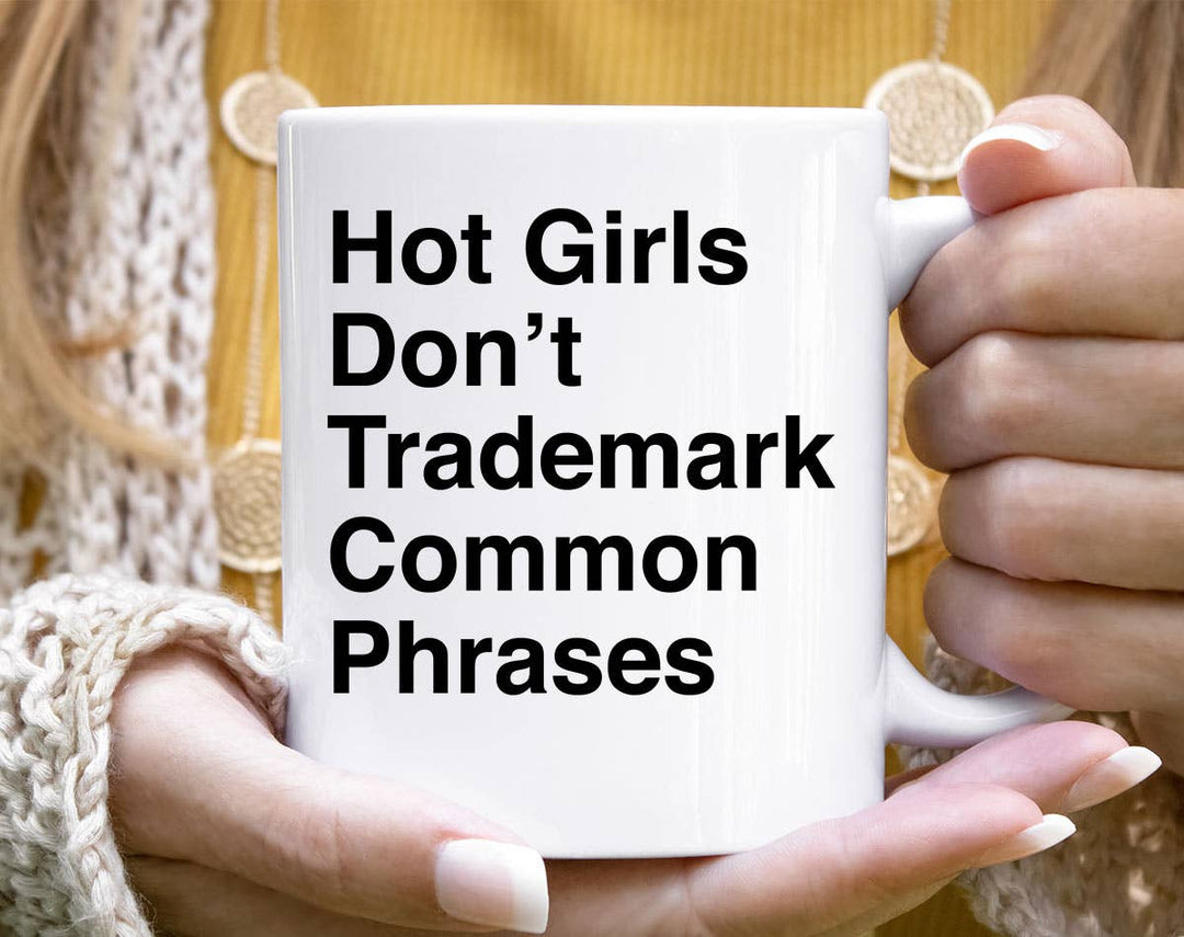 "Hot Girl Don't Trademark Common Phrases Book" design on a white ceramic coffee mug