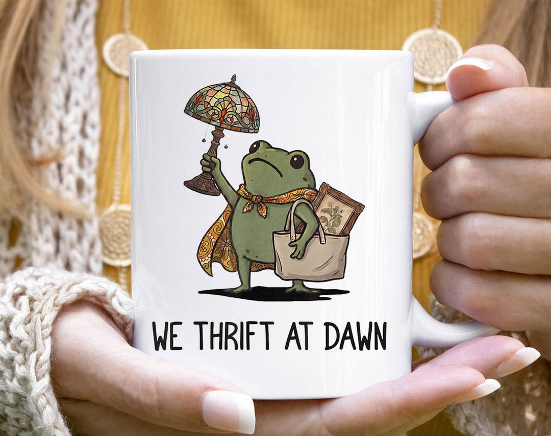 "We Thrift At Dawn Funny Frog Antique Shopping" design on a white ceramic coffee mug
