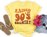 "Raised On 90s Country" design on a pale yellow unisex t-shirt