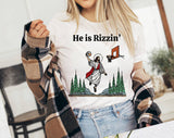 "He Is Rizzen'" design on a white unisex t-shirt