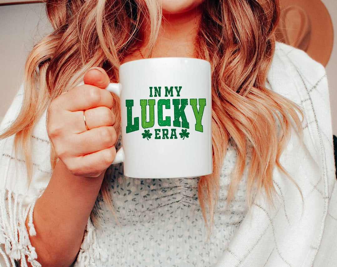 "In My Lucky Era" design on a white ceramic coffee mug