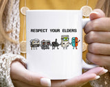 "Respect Your Elders Funny Gaming Controllers" design on a white ceramic coffee mug