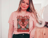 "Nashville Pink Wing" design on a peach unisex t-shirt
