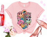 "Summer Pink Flamingo" design on a peach unisex t-shirt