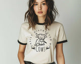 "Easily Distracted By Cows Highland Cow" design on a natural ringer t-shirt with black contrast trim