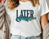 "Later Alligator" design on a white unisex t-shirt