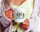 "Booktrovert" design on a white ceramic coffee mug